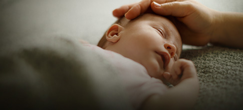 Hand on baby's head