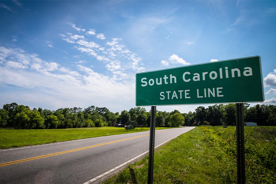 A sign on the side of the road marks the South Carolina state line