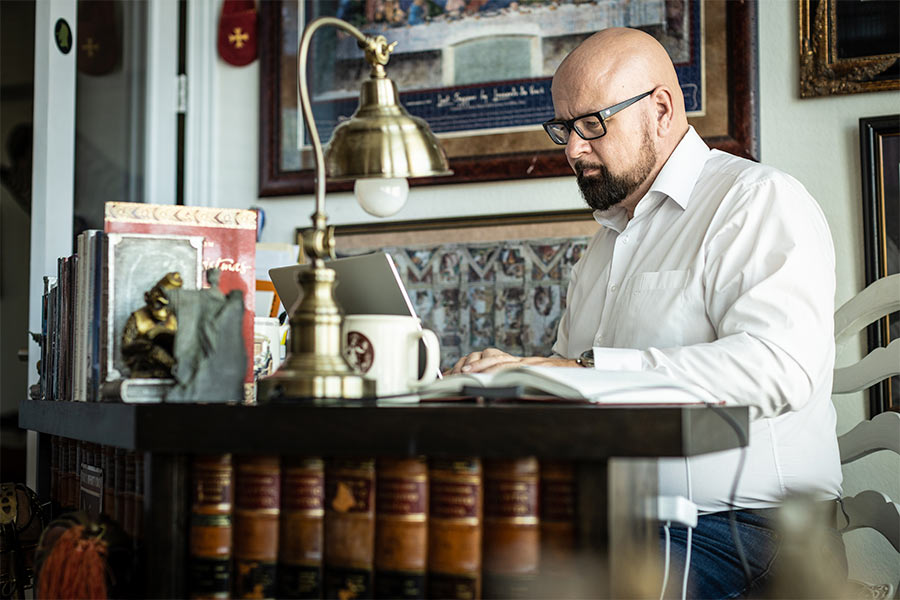 Dr. Andrew Fox sits at his desk at home